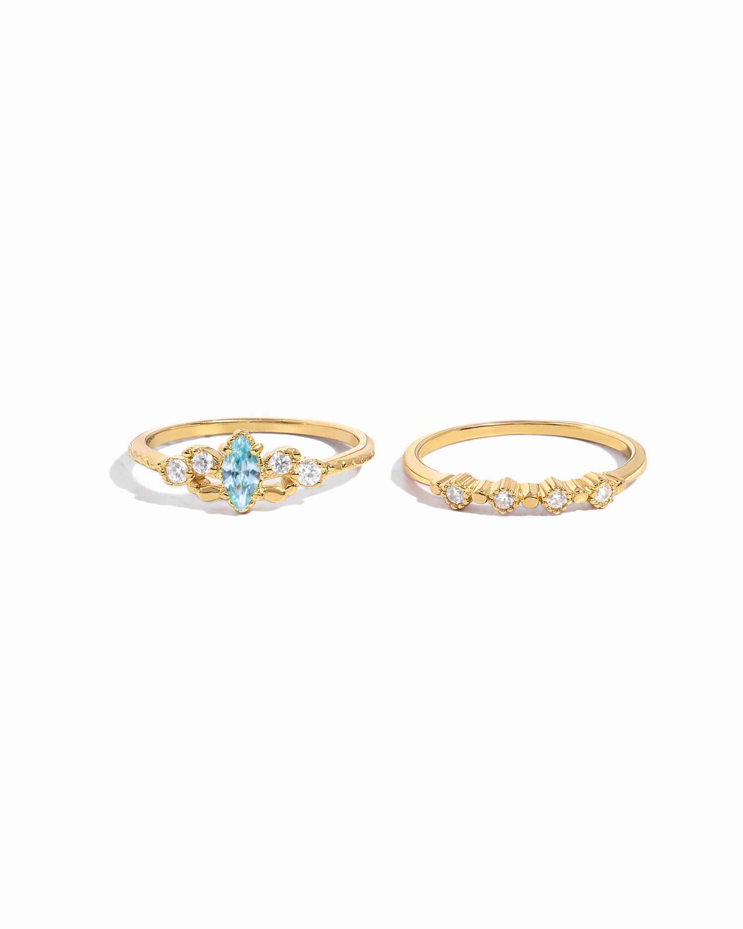 gold aquamarine ring set, one ring with aquamarine marquise stone and cz stones surrounded, and a thin cz stacking ring