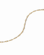 Delicate gold bracelet with small diamonds on a white background