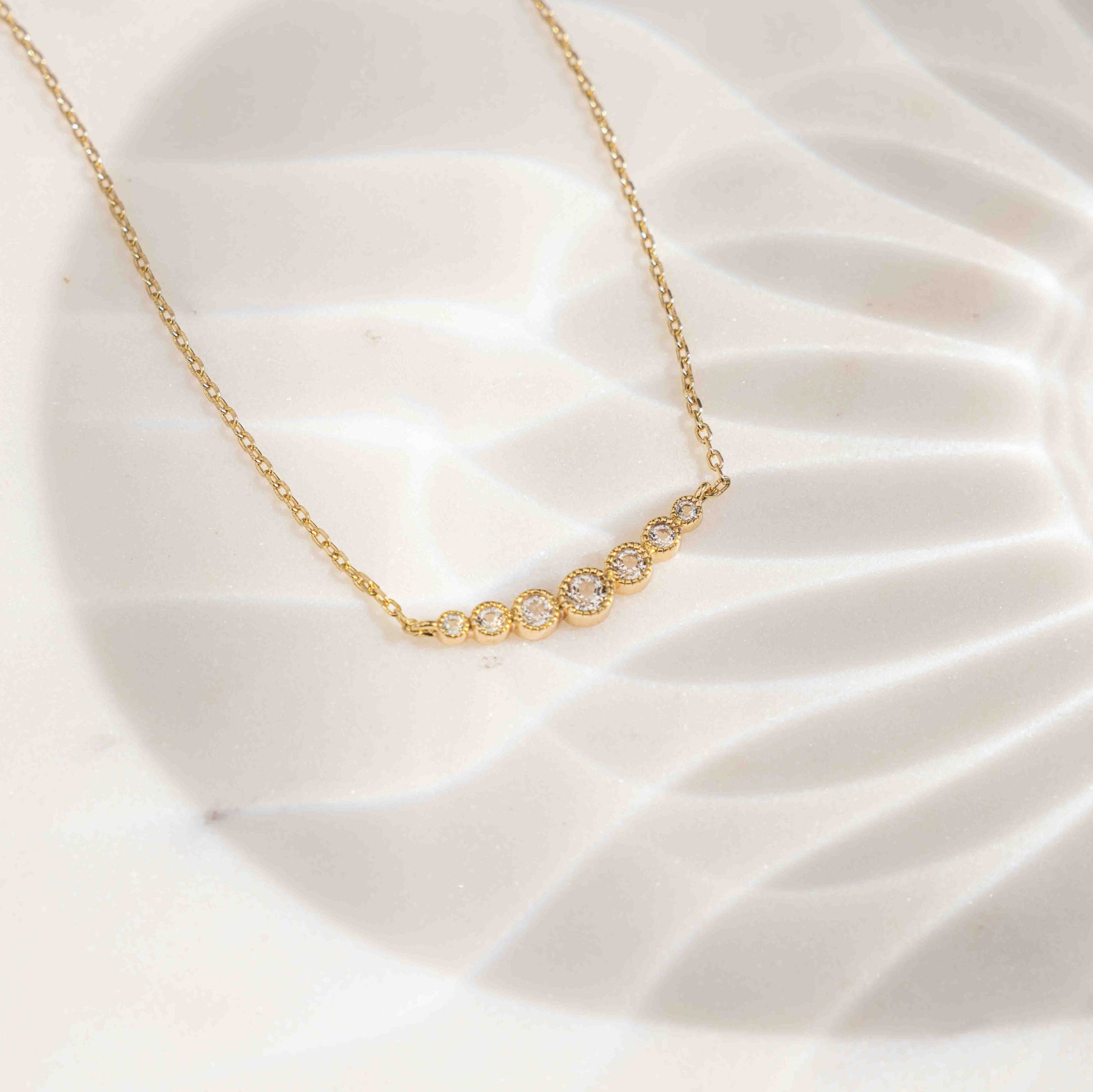 Gold simple bar necklace for women on white background