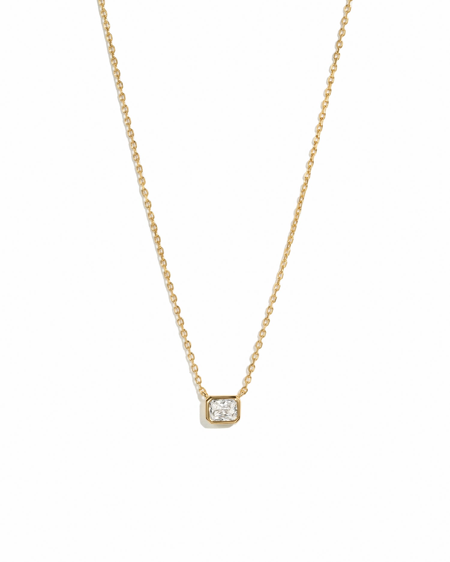 Sami Jewels dainty gold necklace with a diamond bezel pendant on a white background