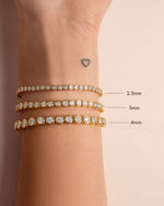 Gold 2.5mm round bezel tennis bracelet by Sami Jewels featuring sleek, polished design with evenly spaced round bezels.