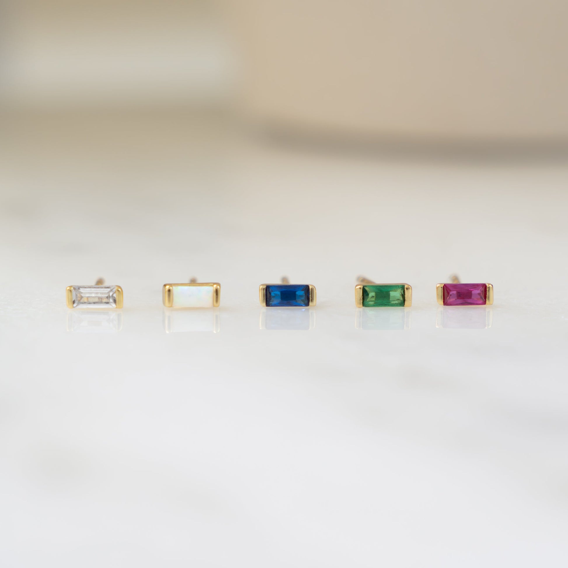 Closeup image of dainty gemstone tiny stud earrings