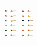 Collection of small stud earrings on a white background with different birthstones