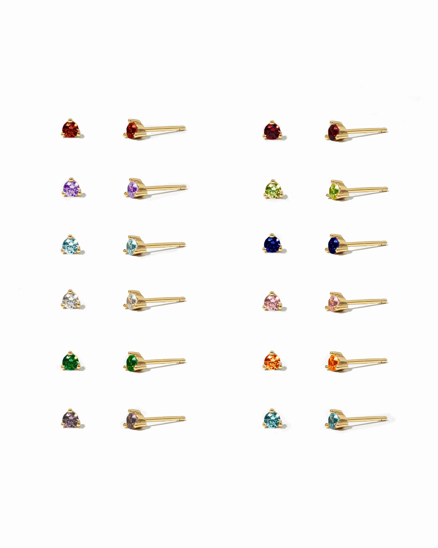 Collection of small stud earrings on a white background with different birthstones