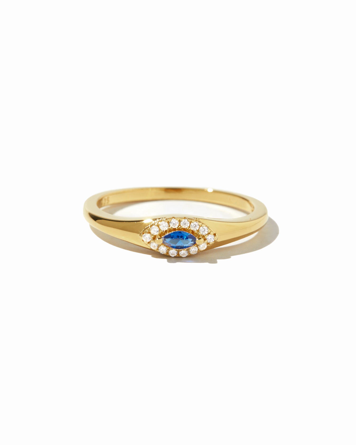 Gold ring with a blue gemstone and evil eye design