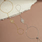 image of two chain bracelets featuring a gold ring bracelet, and a silver adjustable bracelet