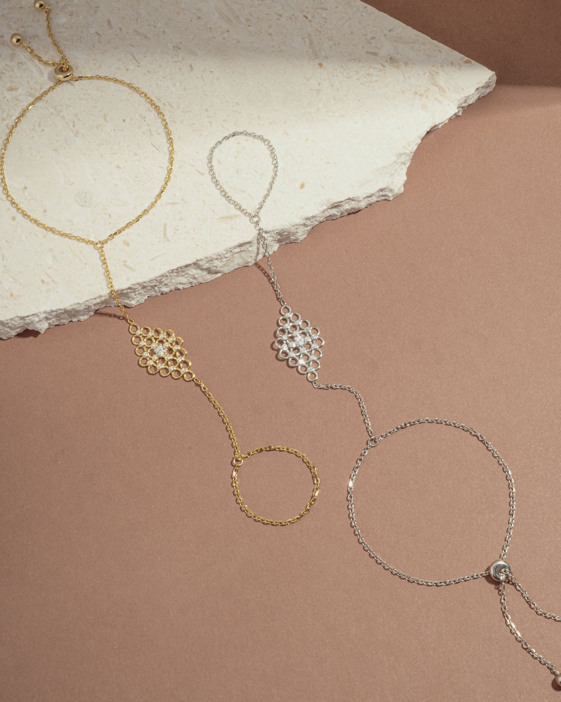 image of two chain bracelets featuring a gold ring bracelet, and a silver adjustable bracelet