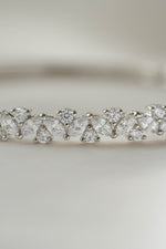 Closeup image of cubic zirconia diamonds from a silver diamond bracelet on a light background