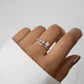 Sami Jewels 925 Sterling Silver Bypass Ring with 5 CZ diamonds on a person's finger against a white background