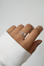 Sami Jewels 925 Sterling Silver Bypass Ring with 5 CZ diamonds on a person's finger against a white background