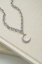 Sami Jewels Moon Statement Necklace featuring a celestial moon pendant on a delicate chain, perfect for elegant jewelry styling.