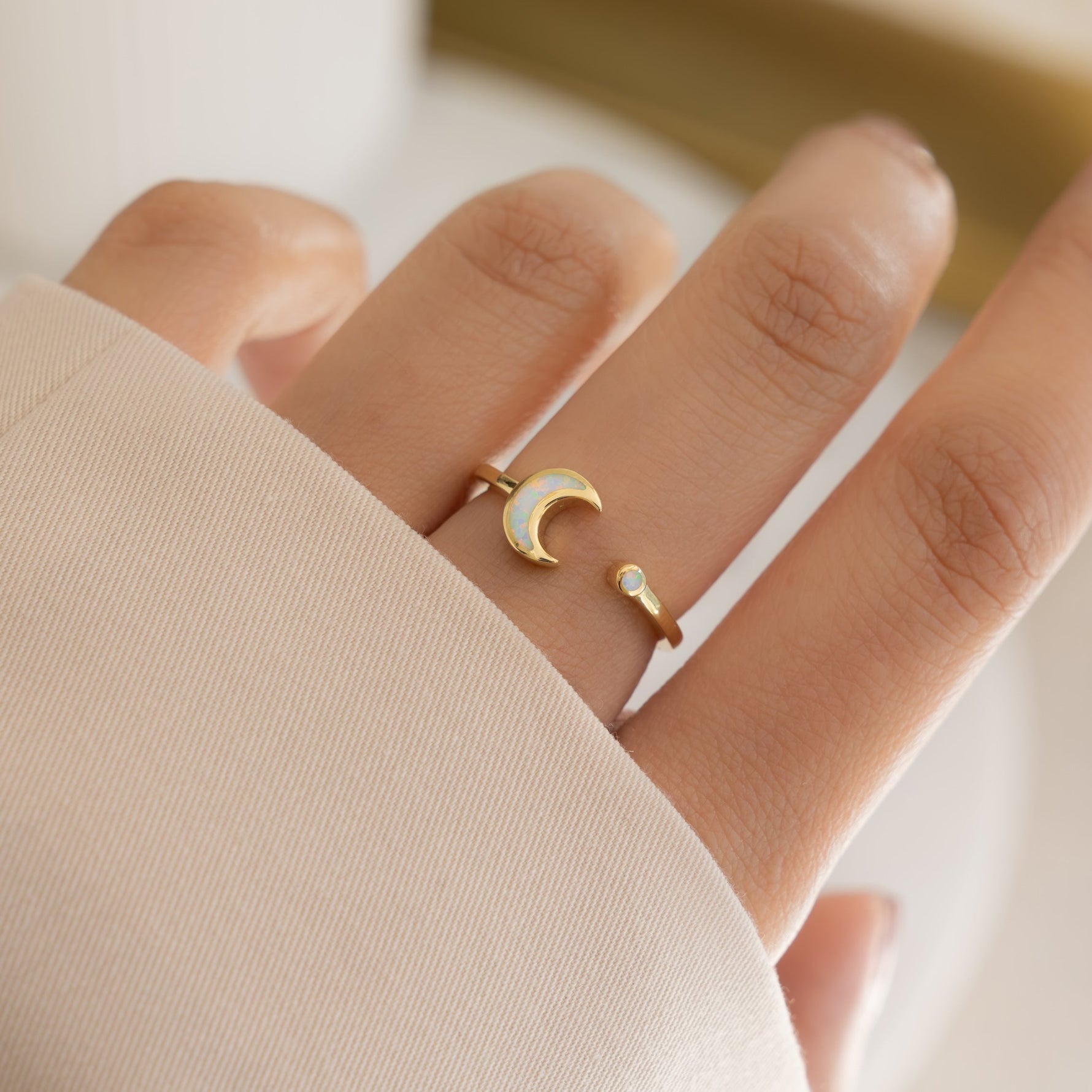 model wearing delicate opal moon ring