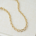 Closeup image of gold jewelry gift featuring chunky chain necklace 