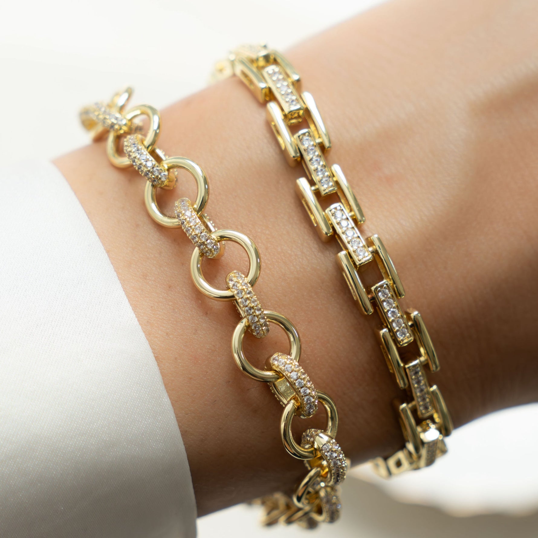 Model showing off gold jewelry featuring gold diamond chain link bracelet 