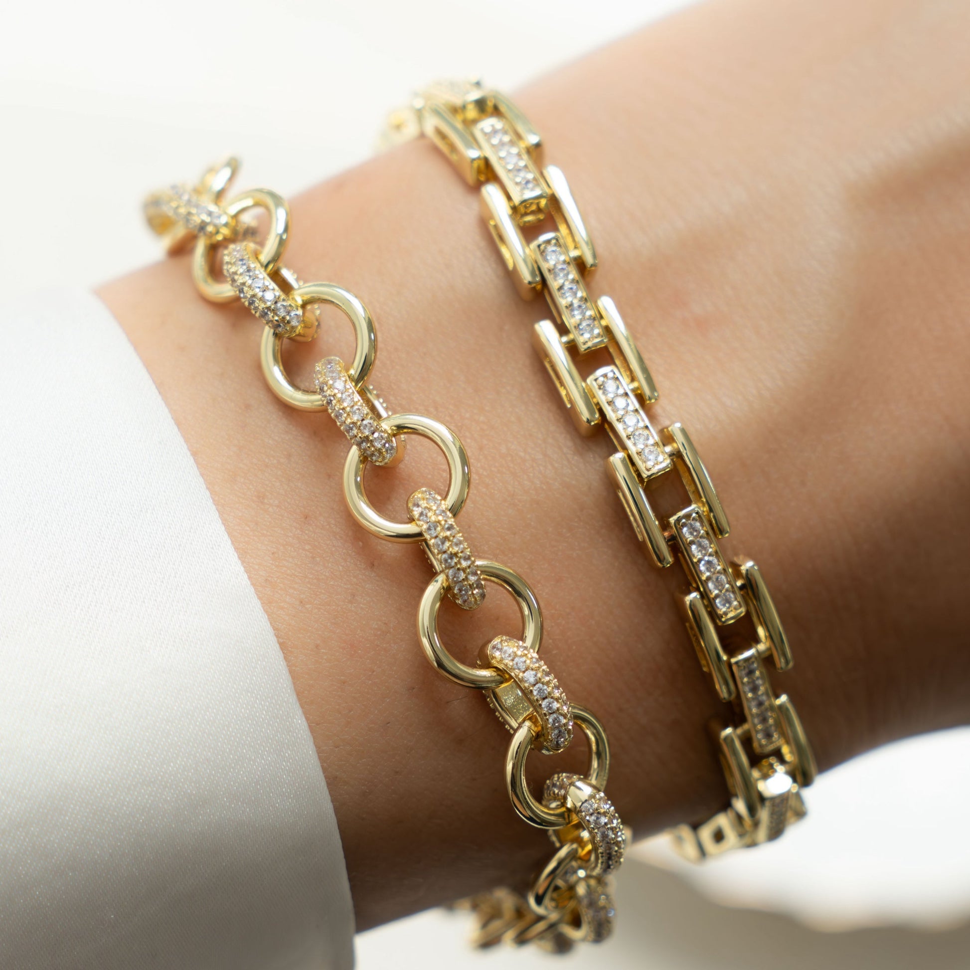 Model showing off gold jewelry featuring gold diamond chain link bracelet 