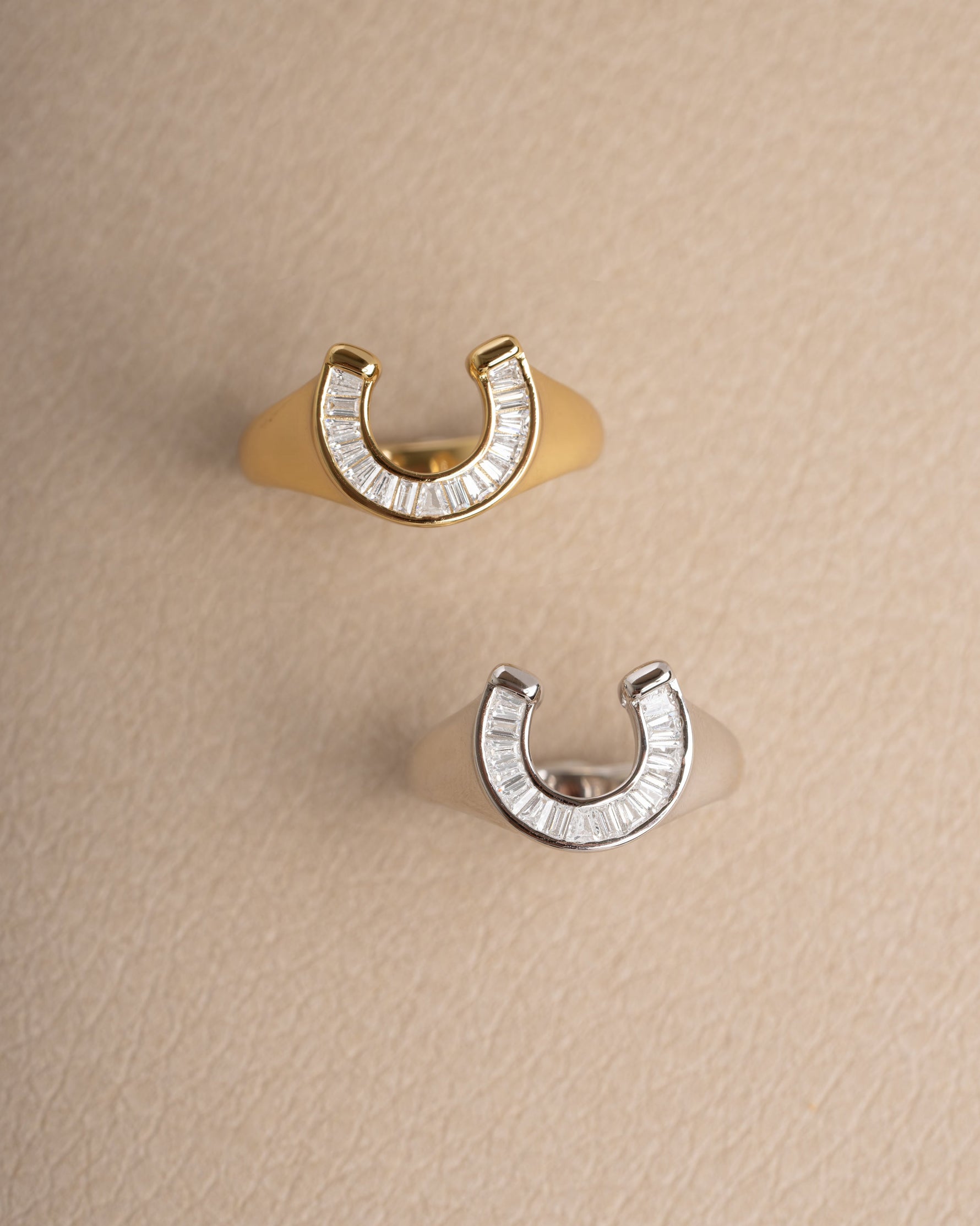 Statement jewelry featuring a gold and sterling silver horseshoe ring with a signet ring design
