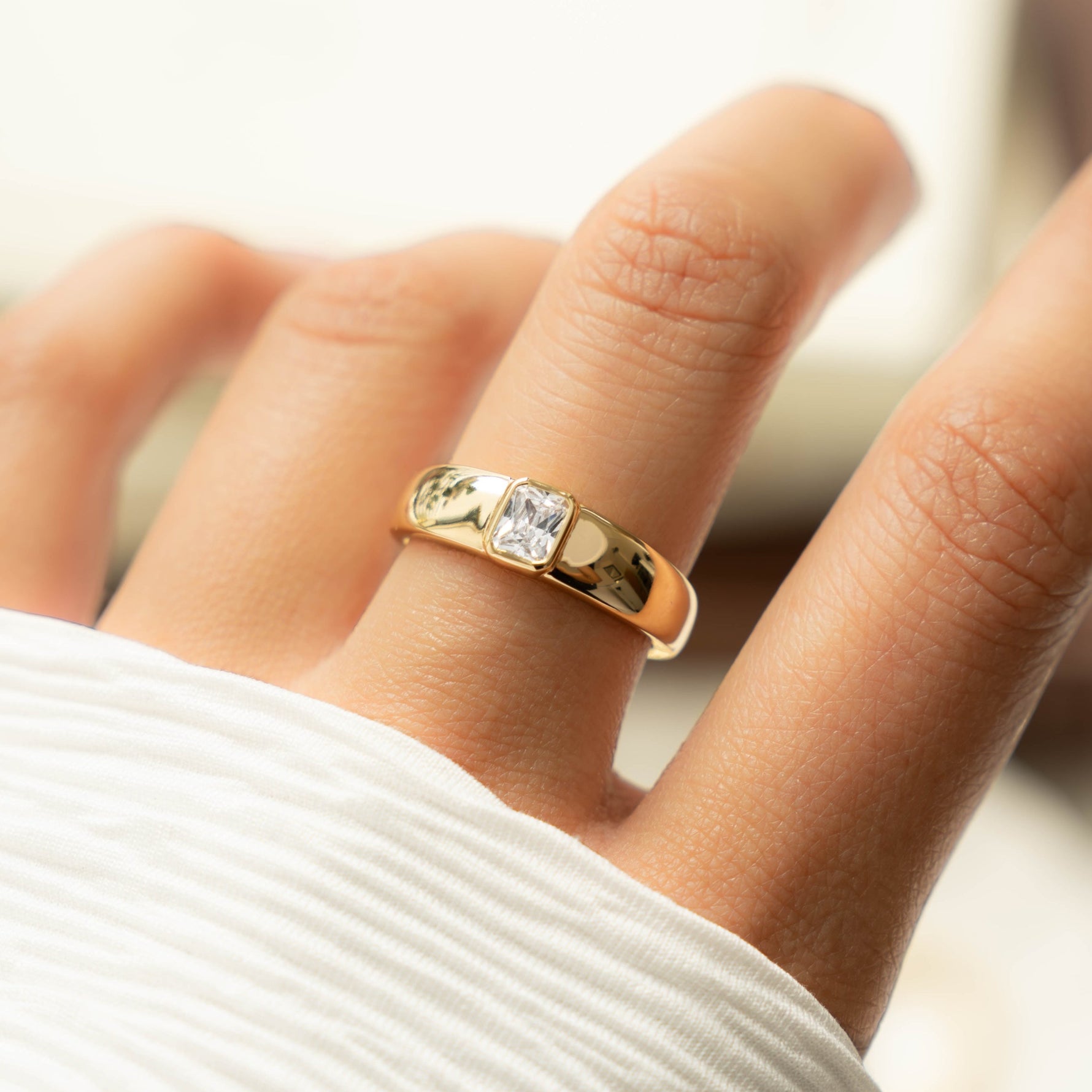 model wearing chunky gold dome ring