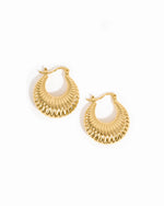 Gold chunky hoops on a white background