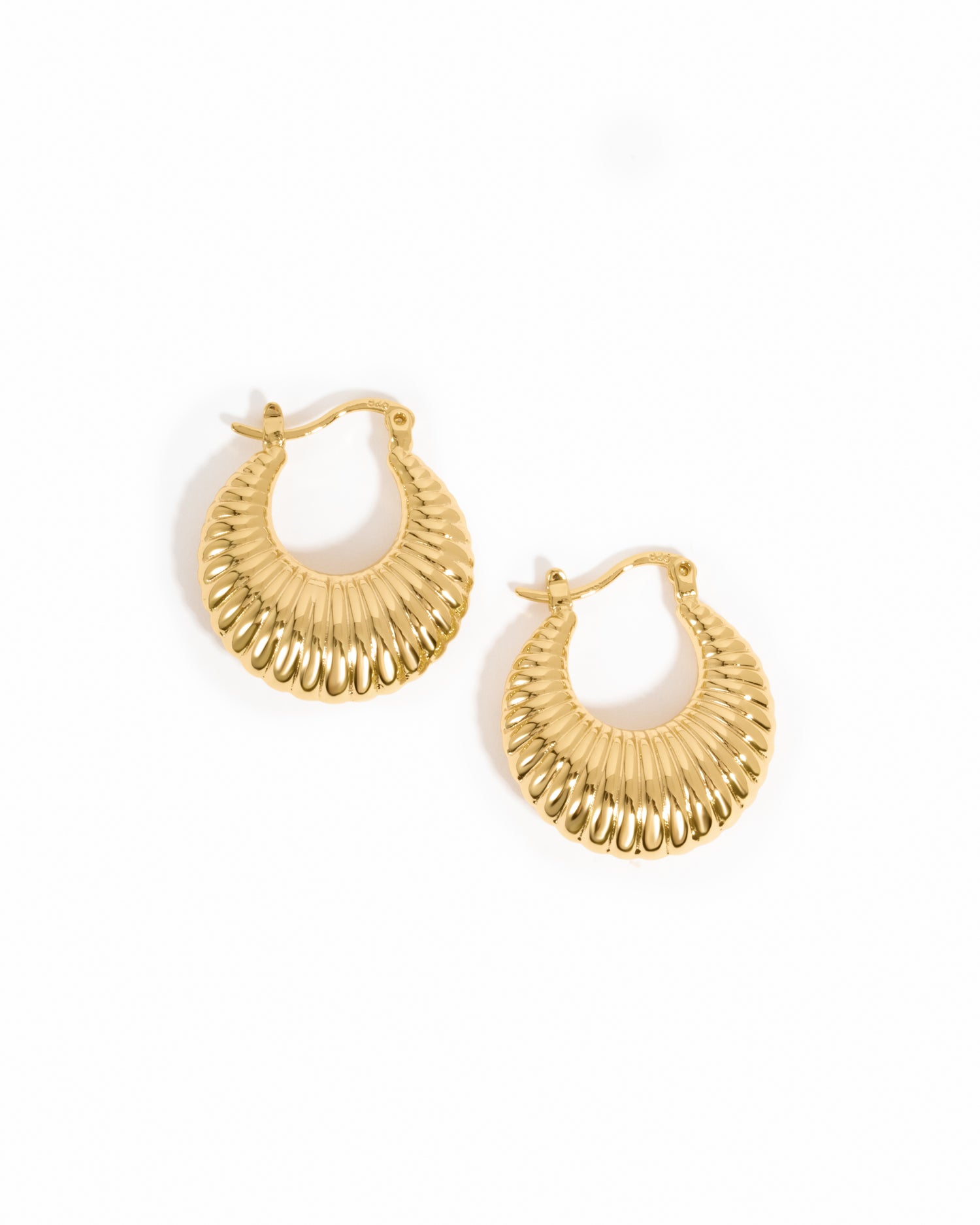 Gold chunky hoops on a white background