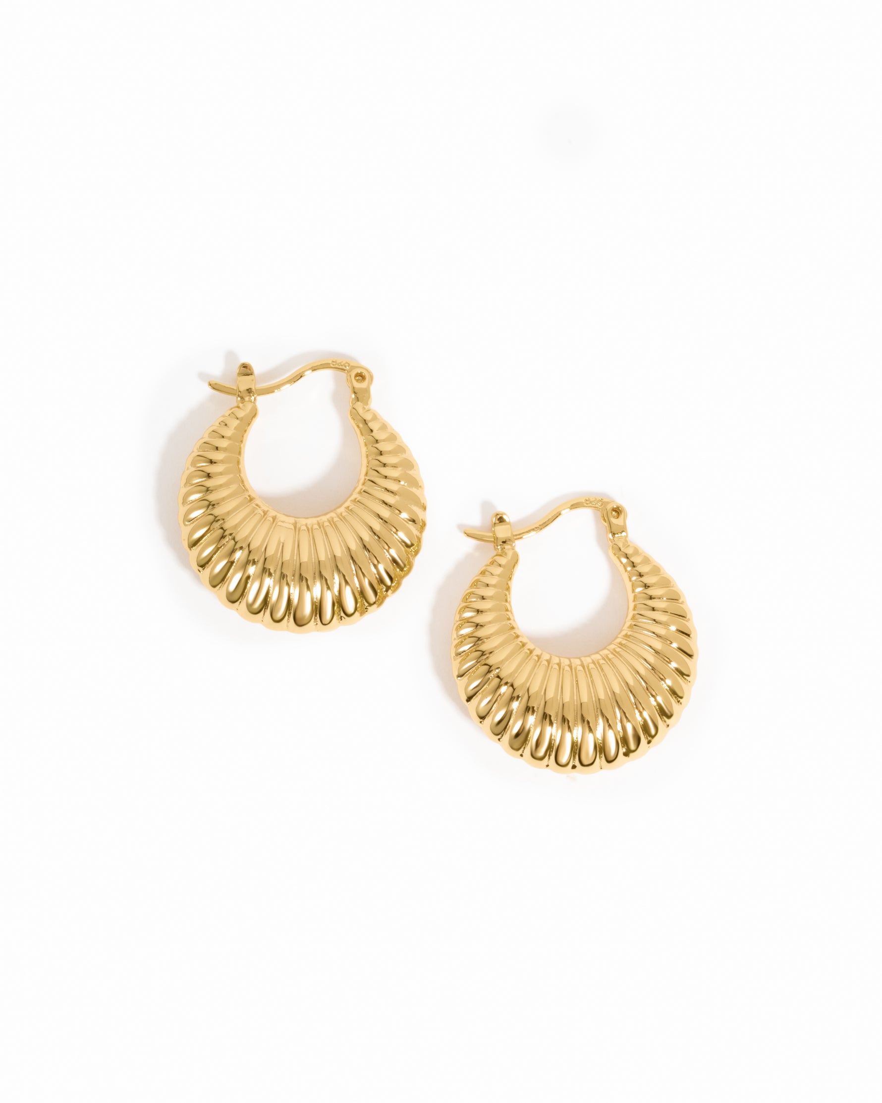 Gold chunky hoops on a white background