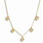 flat lay of a van cleef inspired charm necklace consisting of 5 small diamond four leaf clover charms