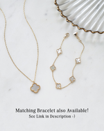 closeup image of gold clover necklace with matching gold four leaf clover bracelet