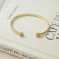 closeup image of gold cubic zirconia cuff bracelet