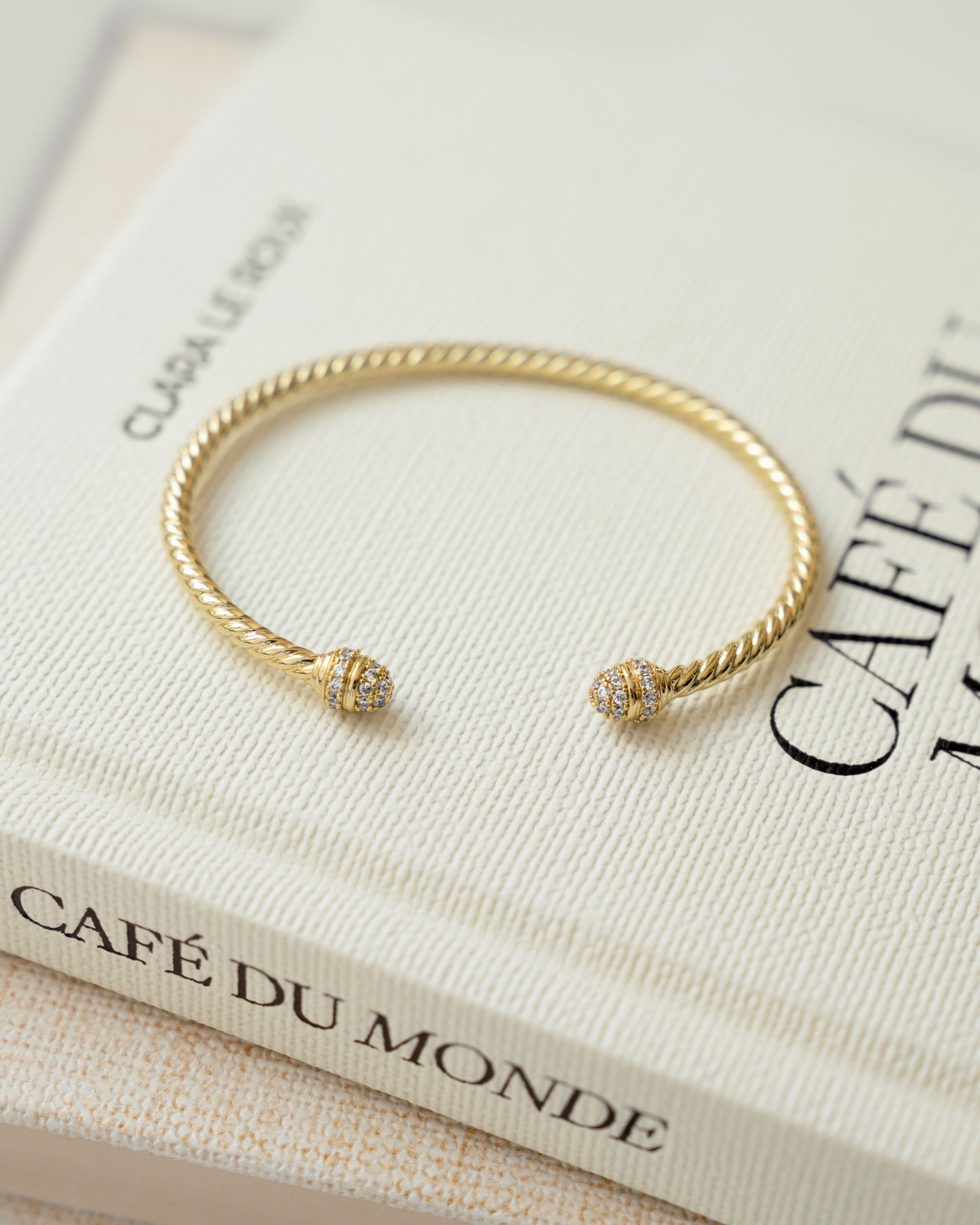 closeup image of gold cubic zirconia cuff bracelet
