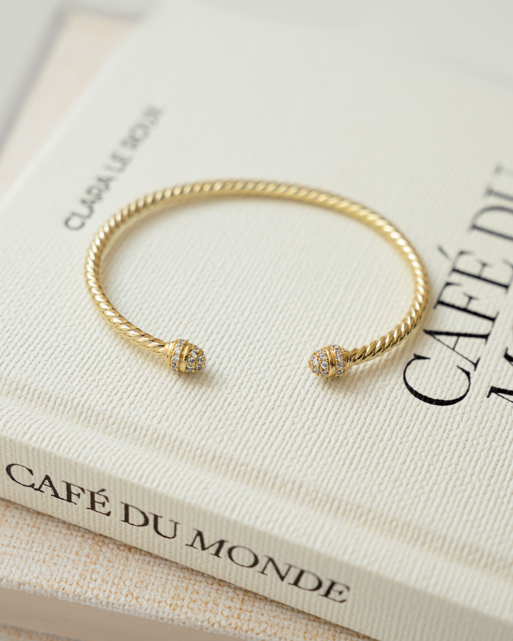 closeup image of gold cubic zirconia cuff bracelet
