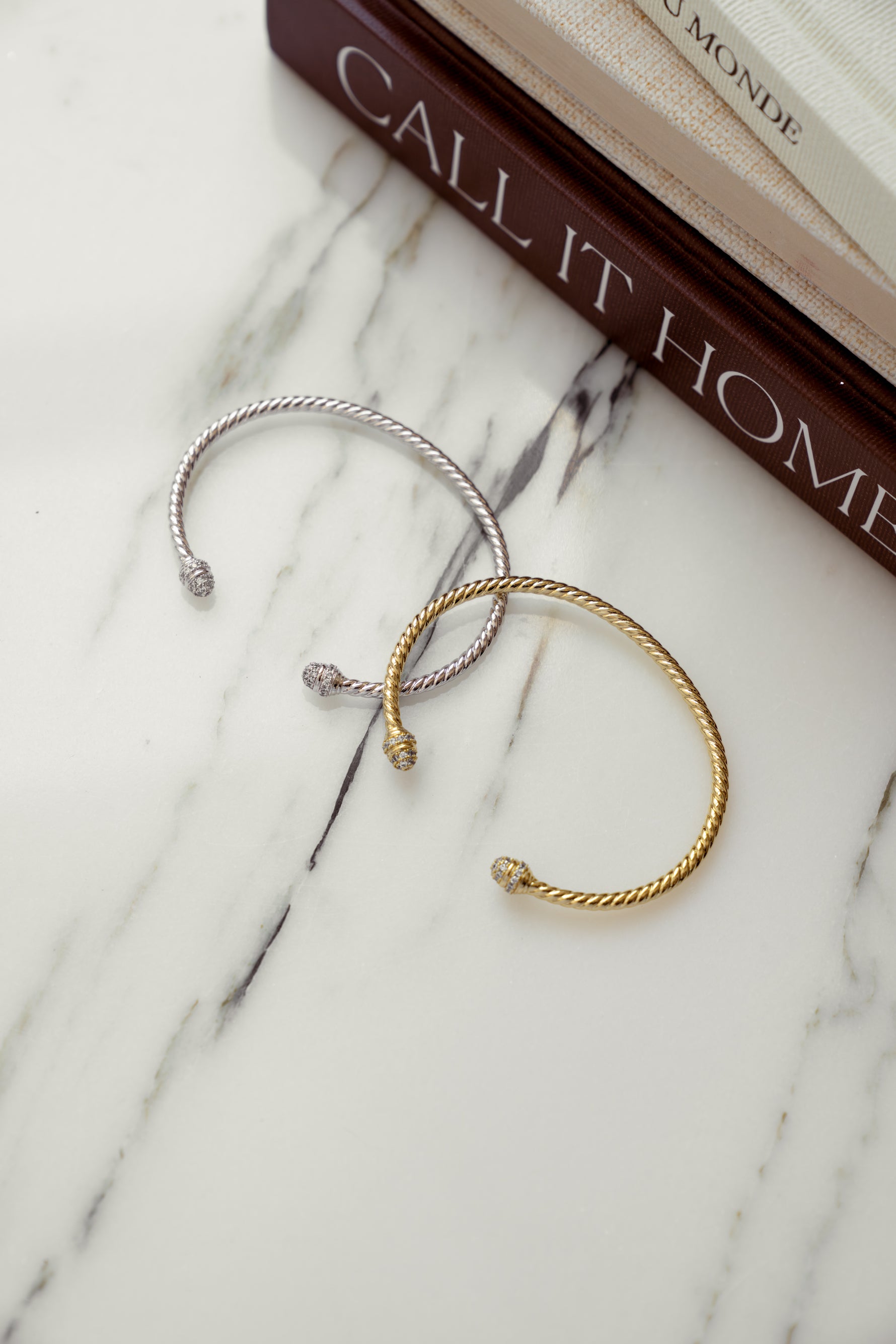 Sami Jewels twisted bangle cuff bracelet with textured metal design and open-ended style on a white background.