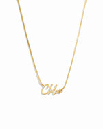 Gold chain custom name necklace with 'chloe' personalized on it, on a white background