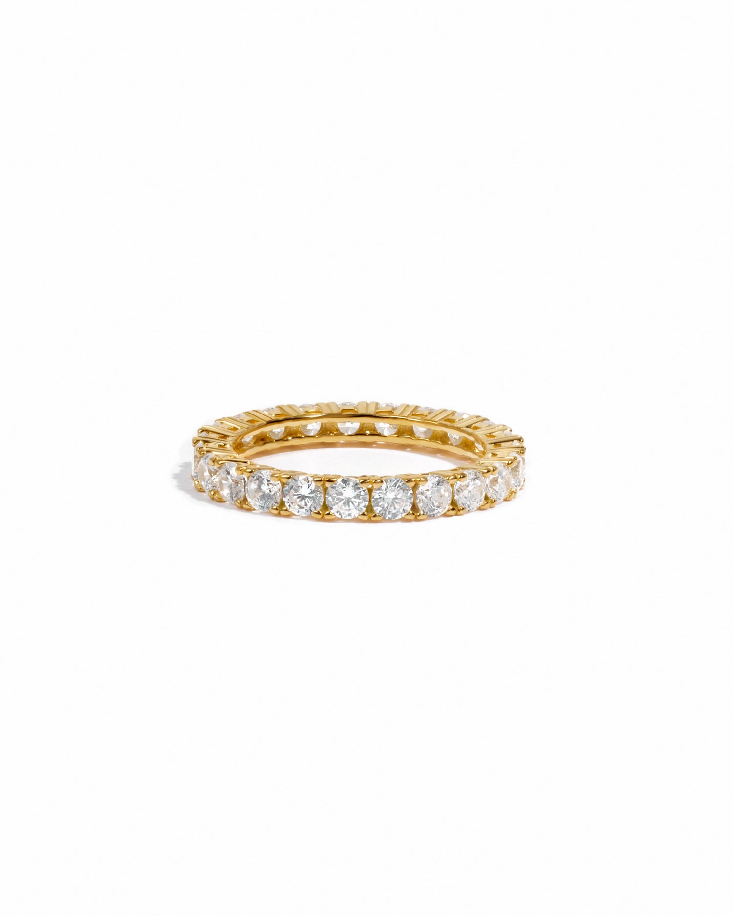 Diamond eternity band in gold on white background. 