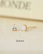 Pair of gold teardrop earrings on a beige background with '3x4 mm' text.