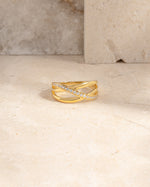 closeup image of gold diamond cz ring on marble background
