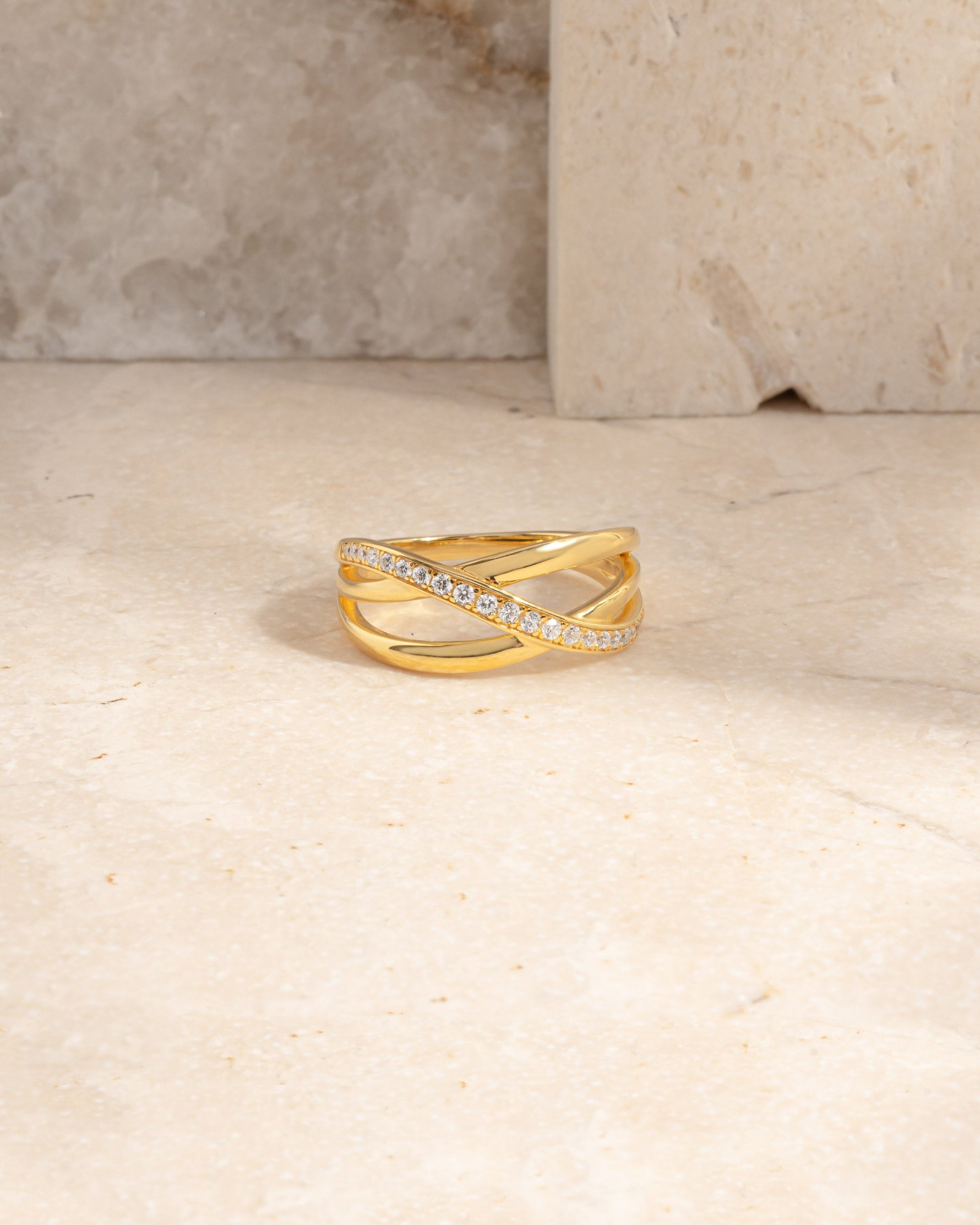 closeup image of gold diamond cz ring on marble background