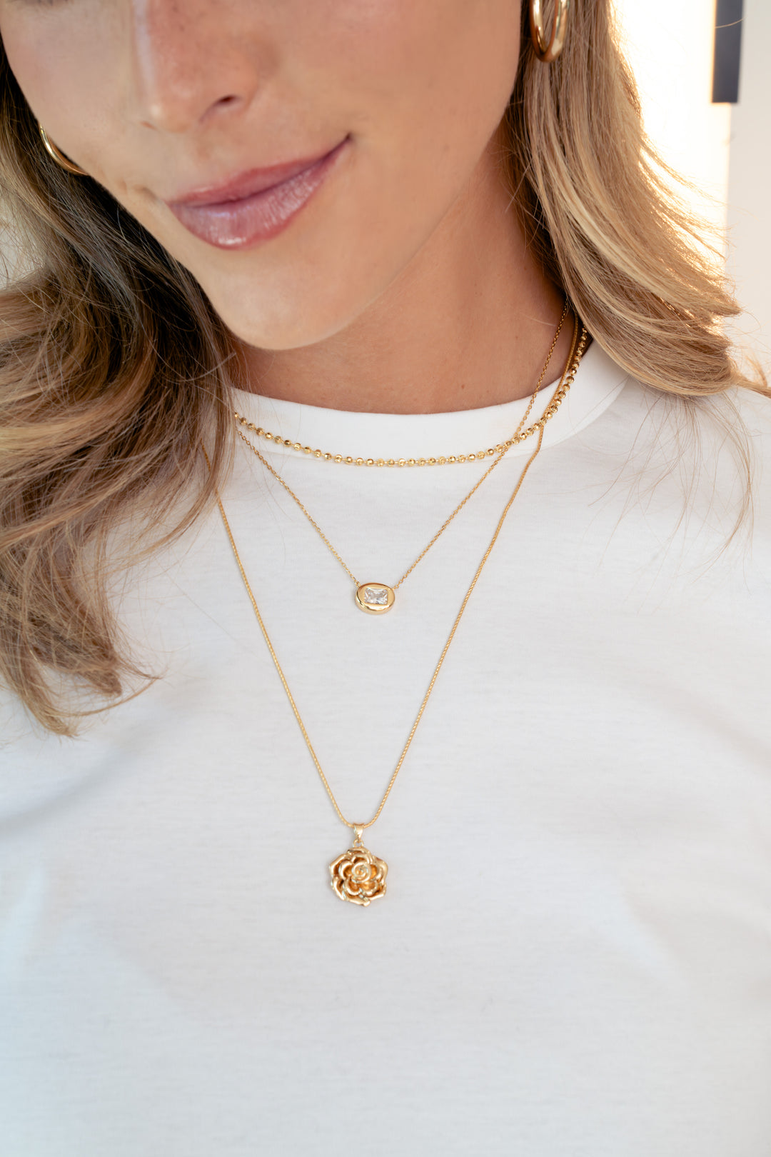 Dainty gold rose necklace for women by Sami Jewels, featuring a delicate rose pendant on a fine chain.