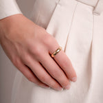 a model showcasing a simple gold ring for women