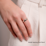 a model wearing a sterling silver band on her pointer finger