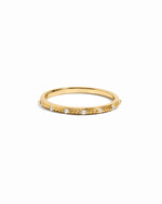 sami jewels gold stacking ring with cubic zirconia stones on a white background