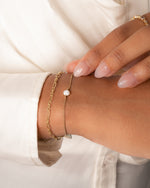 Gold chain link bracelet and a opal chain bracelet on model