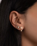 model wearing opal flower earrings and dainty opal studs.