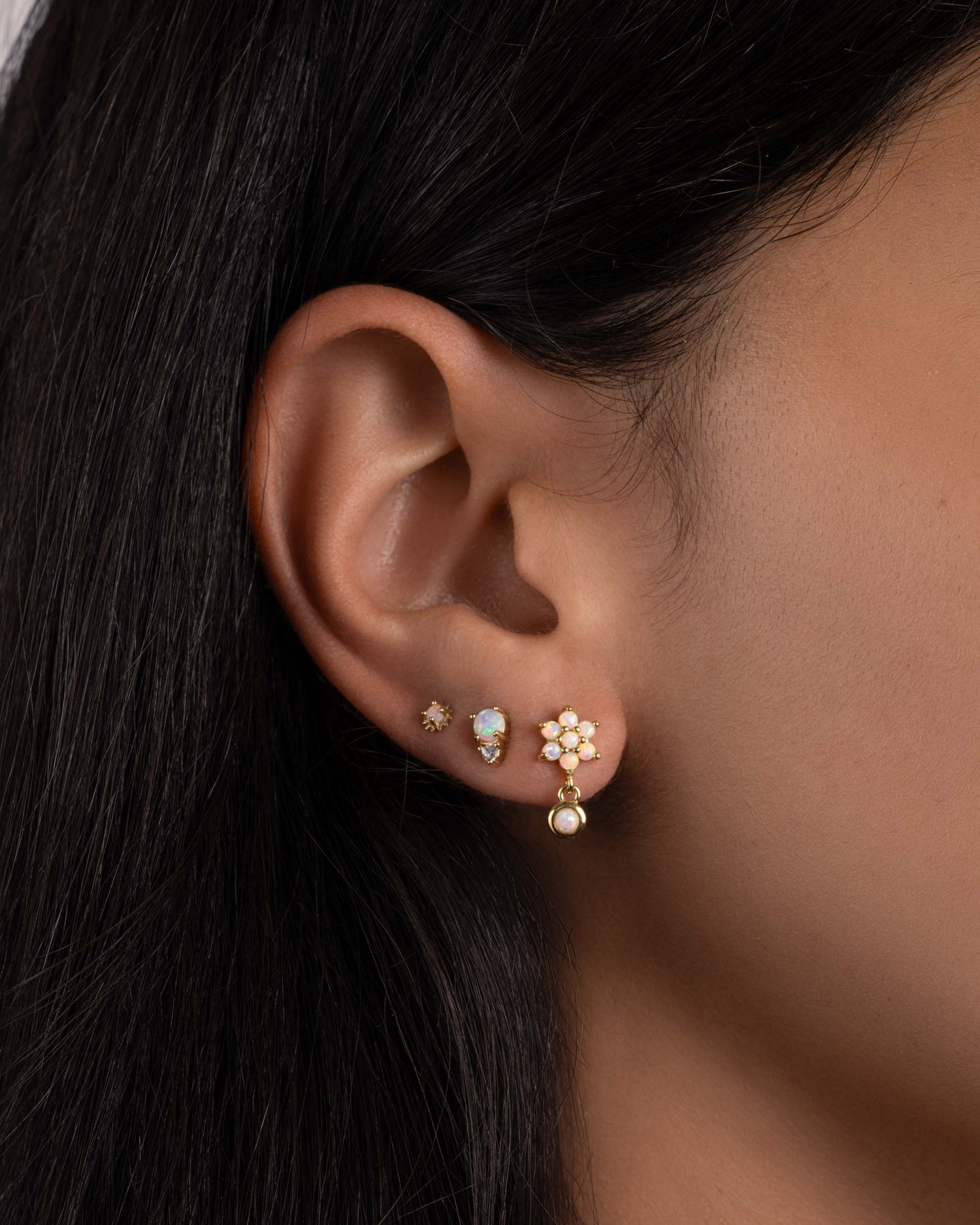 model wearing opal flower earrings and dainty opal studs.