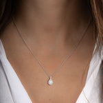 Model wearing minimalist necklace in silver with opal pendant