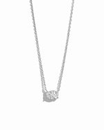Silver necklace with a oval shaped cubic zirconia pendant on a white background