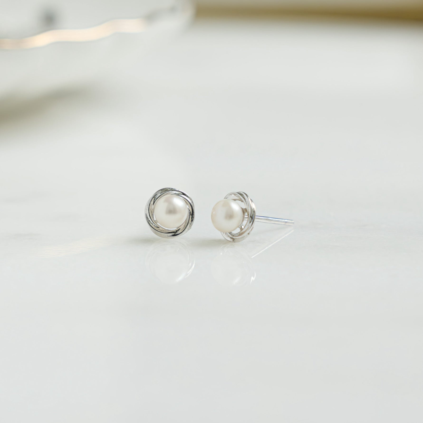 Closeup of silver pearl stud earrings