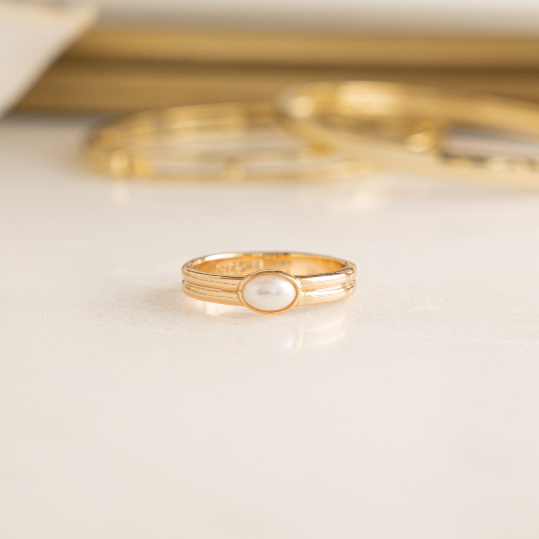 Closeup image of gold dainty pearl ring
