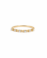 Gold ring with six small diamonds on a white background