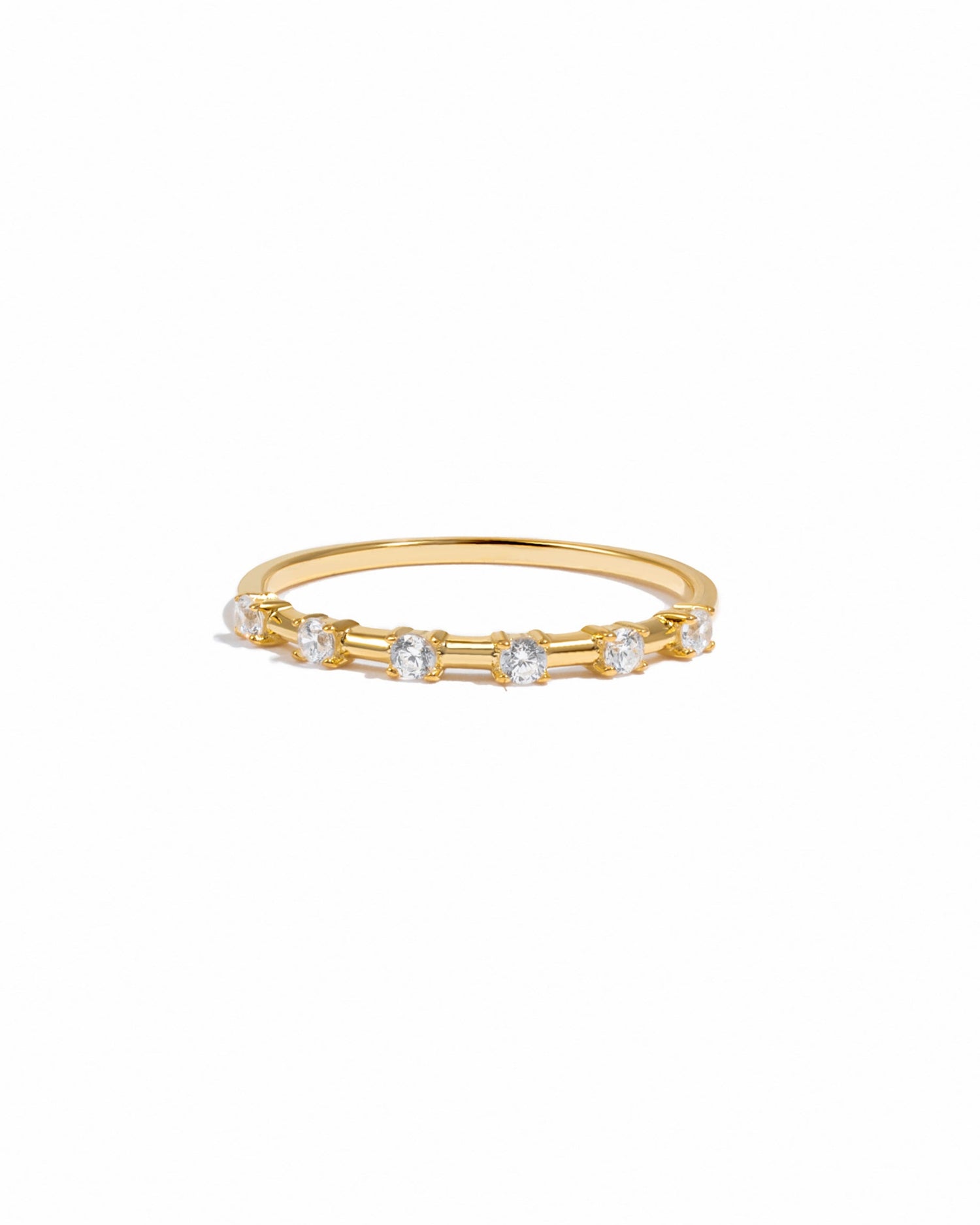 Gold ring with six small diamonds on a white background