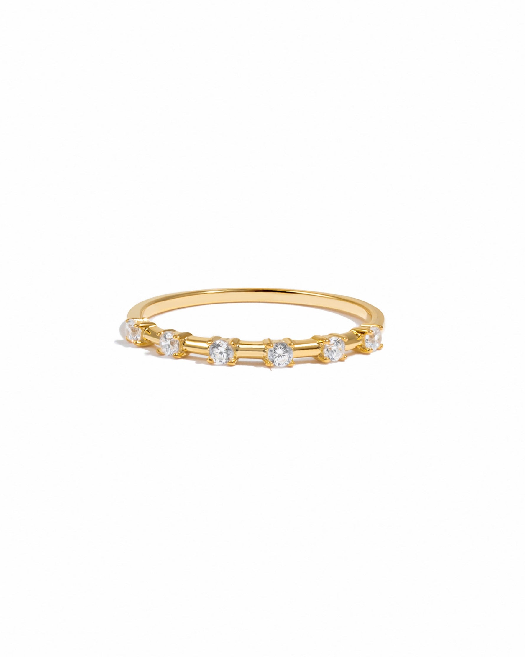 Gold ring with six small diamonds on a white background