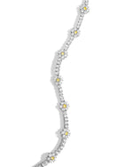Silver necklace with small yellow stones in a floral design on a white background